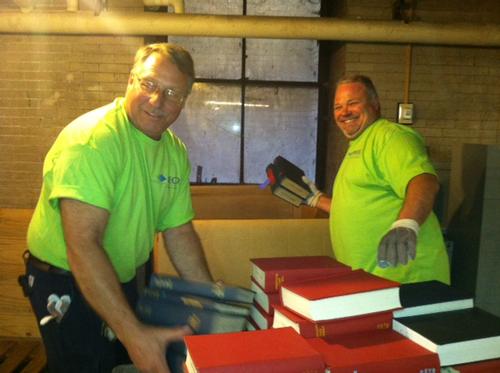 Volunteers from PECO help move library materials in the stacks.
